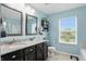A spacious bathroom offers double sinks with granite countertops, a toilet, and a window at 1281 Jesse Ct, Greenwood, IN 46143