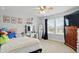 Bright bedroom features a ceiling fan, a window, and a vanity with a mirror and drawers at 1281 Jesse Ct, Greenwood, IN 46143