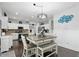 Bright dining area features a decorative table with bench seating, and stylish chandelier lighting at 1281 Jesse Ct, Greenwood, IN 46143