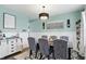 Chandelier above a dining area with adjacent wall decor and cabinet at 1281 Jesse Ct, Greenwood, IN 46143