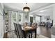 Dining area with views into the living room, a chandelier and lots of natural light at 1281 Jesse Ct, Greenwood, IN 46143