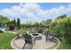 Charming backyard fire pit area surrounded by Adirondack chairs and verdant landscaping at 1281 Jesse Ct, Greenwood, IN 46143