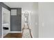 Hallway with hardwood floors, decorative rug, and ample lighting leads to various rooms at 1281 Jesse Ct, Greenwood, IN 46143