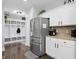 Spacious kitchen with stainless refrigerator and convenient mud room and storage area at 1281 Jesse Ct, Greenwood, IN 46143