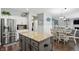 Open kitchen boasts stainless appliances, granite island, and seamless flow to dining and living areas at 1281 Jesse Ct, Greenwood, IN 46143