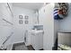 Well-organized laundry room has a washer, dryer, and plenty of cabinet space for storage at 1281 Jesse Ct, Greenwood, IN 46143