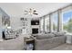 Cozy living room featuring a fireplace, ceiling fan, and lots of natural light at 1281 Jesse Ct, Greenwood, IN 46143