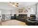 Cozy living room features a black leather reclining set, ceiling fan, and a large area rug at 1281 Jesse Ct, Greenwood, IN 46143