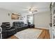 Spacious living room features theater chairs, movie art, and a ceiling fan for comfort at 1281 Jesse Ct, Greenwood, IN 46143