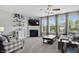 Spacious living room with fireplace, ceiling fan, and large windows for ample natural light at 1281 Jesse Ct, Greenwood, IN 46143
