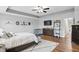 Comfortable main bedroom with wood-look flooring, a ceiling fan, and decor art pieces at 1281 Jesse Ct, Greenwood, IN 46143