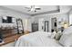 Bright main bedroom with a ceiling fan, wood-look floors, and an ensuite bathroom and walk-in closet at 1281 Jesse Ct, Greenwood, IN 46143