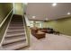 Stairway leading down to a finished basement, with a comfortable seating area at 13271 Aquamarine Dr, Carmel, IN 46033