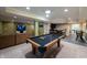 Basement boasts a pool table, bar area, and comfortable seating, perfect for entertaining guests at 13271 Aquamarine Dr, Carmel, IN 46033