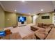 Basement living room with large sectional sofa, TV, and neutral decor at 13271 Aquamarine Dr, Carmel, IN 46033