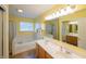 Large bathroom with a double vanity, garden tub, and a shower with glass doors at 13271 Aquamarine Dr, Carmel, IN 46033