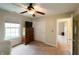 Bright bedroom with a ceiling fan, dresser, and a large window providing natural light at 13271 Aquamarine Dr, Carmel, IN 46033