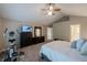 Bright bedroom featuring neutral walls, carpet, and a comfortable king-sized bed, and a large dresser with a TV at 13271 Aquamarine Dr, Carmel, IN 46033