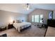 Spacious bedroom features a vaulted ceiling, plush carpet, and a comfortable king-sized bed with ample natural light at 13271 Aquamarine Dr, Carmel, IN 46033
