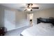 Neutral bedroom features a ceiling fan and an open doorway to another room at 13271 Aquamarine Dr, Carmel, IN 46033
