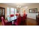 Elegant dining room with hardwood floors, large table, and hutch, offering ample space for entertaining guests at 13271 Aquamarine Dr, Carmel, IN 46033