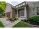 Close-up of a charming brick home's entrance with a well-kept lawn and elegant front door details at 13271 Aquamarine Dr, Carmel, IN 46033