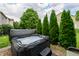 Outdoor hot tub surrounded by lush greenery, providing a private retreat at 13271 Aquamarine Dr, Carmel, IN 46033