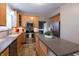 Well-lit kitchen featuring wooden cabinets, stainless steel appliances, and a center island with a stone countertop at 13271 Aquamarine Dr, Carmel, IN 46033