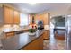 Cozy kitchen with light wood cabinets, stainless appliances, island, and backsplash, perfect for Gathering meals at 13271 Aquamarine Dr, Carmel, IN 46033