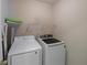 This laundry room features a washer and dryer, a shelf and neutral color scheme at 13271 Aquamarine Dr, Carmel, IN 46033