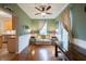 Cozy living room with a tan sofa, bright windows, wood floors, and adjacent open kitchen at 13271 Aquamarine Dr, Carmel, IN 46033