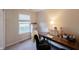 This office has a neutral color palette, a desk with a computer, and a large window at 13271 Aquamarine Dr, Carmel, IN 46033