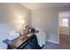 This office features a dark wood desk, chair, printer and other office decor at 13271 Aquamarine Dr, Carmel, IN 46033