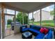 Screened porch with comfortable blue sofa, perfect for enjoying the outdoors at 13271 Aquamarine Dr, Carmel, IN 46033