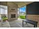 Covered back porch with a brick fireplace and a view of the backyard and neighborhood at 1364 Chatham Hills Blvd, Westfield, IN 46074