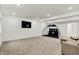 Well-lit basement with wall-mounted TV and relaxing couch, perfect for entertainment at 1364 Chatham Hills Blvd, Westfield, IN 46074
