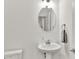 Bright half bathroom features pedestal sink, oval mirror, and modern fixtures at 1364 Chatham Hills Blvd, Westfield, IN 46074