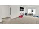 Bright bonus room featuring neutral carpet, white walls, toys, and a television at 1364 Chatham Hills Blvd, Westfield, IN 46074