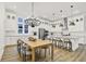 Open dining and kitchen area with modern decor, lighting, and stainless steel appliances at 1364 Chatham Hills Blvd, Westfield, IN 46074