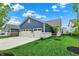 Charming home with a well-manicured lawn, a three-car garage and a blue color scheme at 1364 Chatham Hills Blvd, Westfield, IN 46074