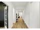 Long hallway featuring hardwood flooring, white walls, and doorways leading to other rooms of the house at 1364 Chatham Hills Blvd, Westfield, IN 46074
