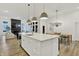 Bright, open layout featuring a kitchen island and adjacent sitting area with a view of the fireplace at 1364 Chatham Hills Blvd, Westfield, IN 46074