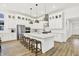 Spacious white kitchen featuring stainless steel appliances, a large island with seating, and pendant lighting at 1364 Chatham Hills Blvd, Westfield, IN 46074