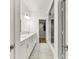 Hallway view of the pristine main bathroom with double vanity, glass shower, and walk-in closet at 1364 Chatham Hills Blvd, Westfield, IN 46074