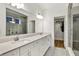 Bright bathroom with double vanity, modern fixtures, large mirror, glass shower, and walk-in closet at 1364 Chatham Hills Blvd, Westfield, IN 46074