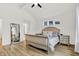 Bright main bedroom featuring vaulted ceilings, a full-length mirror, and light wood flooring at 1364 Chatham Hills Blvd, Westfield, IN 46074