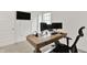 Bright office space featuring a long wooden desk, computer monitors, and a modern black chair at 1364 Chatham Hills Blvd, Westfield, IN 46074