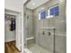 Elegant gray tile shower with bench, glass surround, and nearby walk-in closet at 1364 Chatham Hills Blvd, Westfield, IN 46074