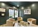 Comfortable sitting area with dark walls, light-colored seating, and natural light streaming through the windows at 1364 Chatham Hills Blvd, Westfield, IN 46074