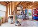 Spacious attic for storage, with shelving and natural light from a window at 14711 Macduff Dr, Noblesville, IN 46062